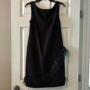 Black sleeveless cocktail dress with feather accents